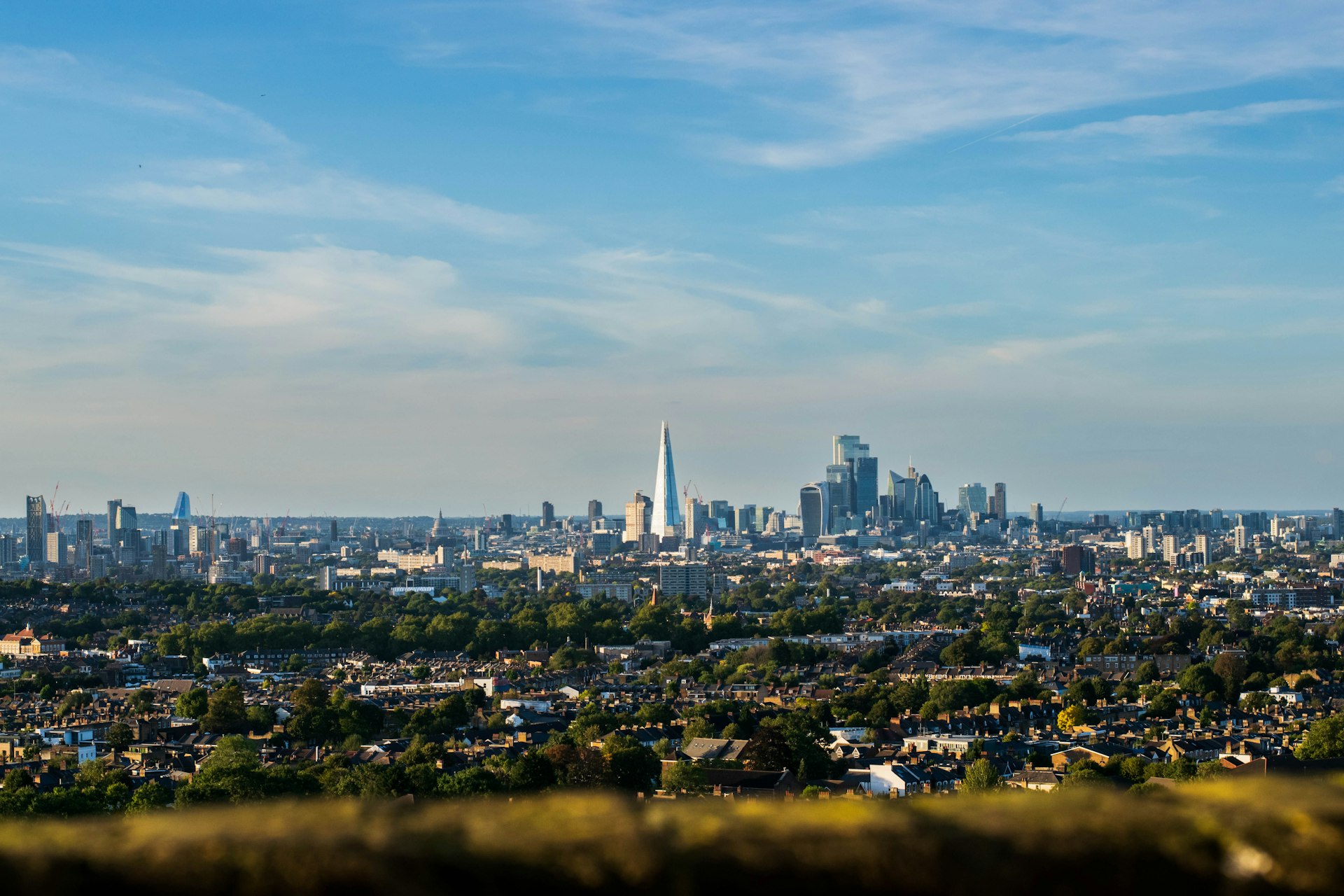 A panoramic view of a bustling financial district skyline, representing large-scale real estate portfolios.