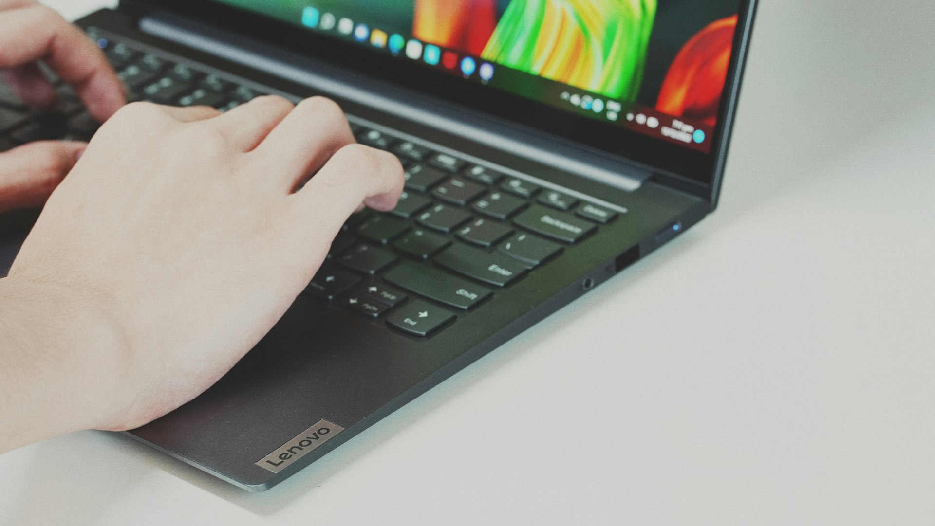 Close-up of hands typing on a computer keyboard in an office setting, representing precise execution of token standards.