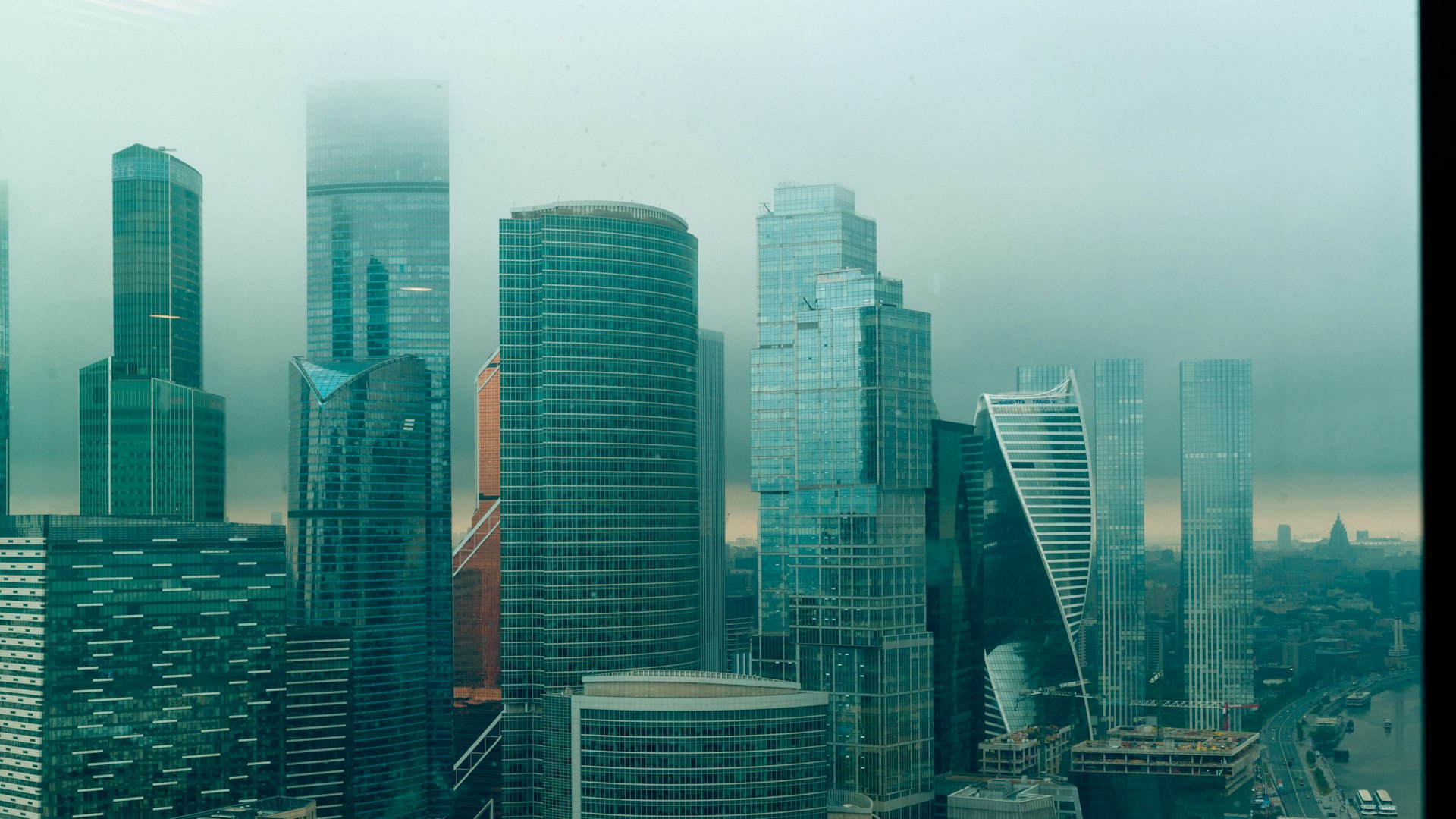 A view of a global city's financial district with multiple modern buildings.