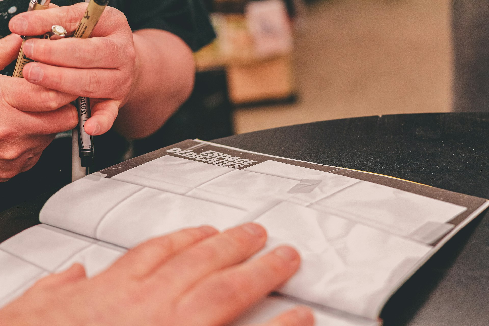 Hands signing legal documents, representing the contractual nature of real estate tokenization.