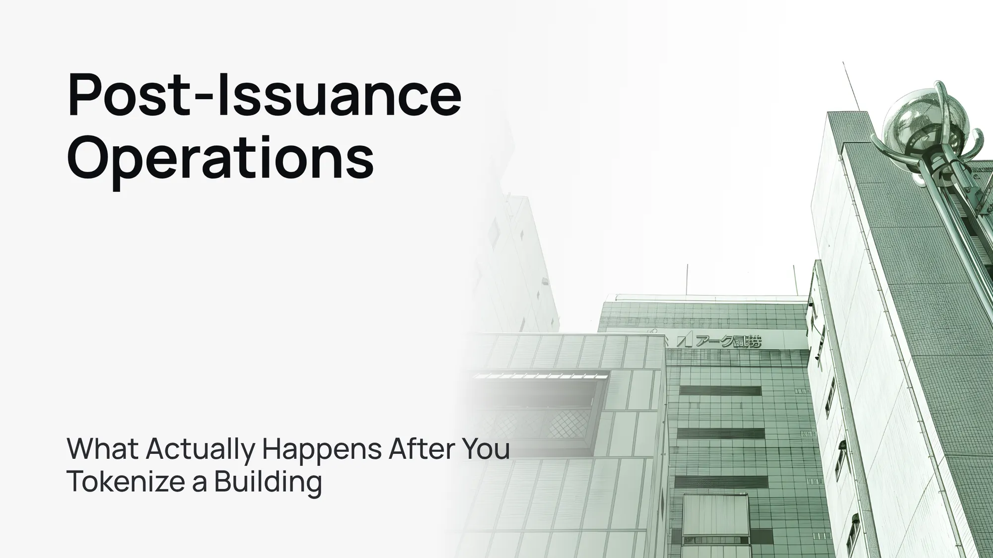 A sleek, modern glass office building against a clear blue sky, symbolizing real estate tokenization.