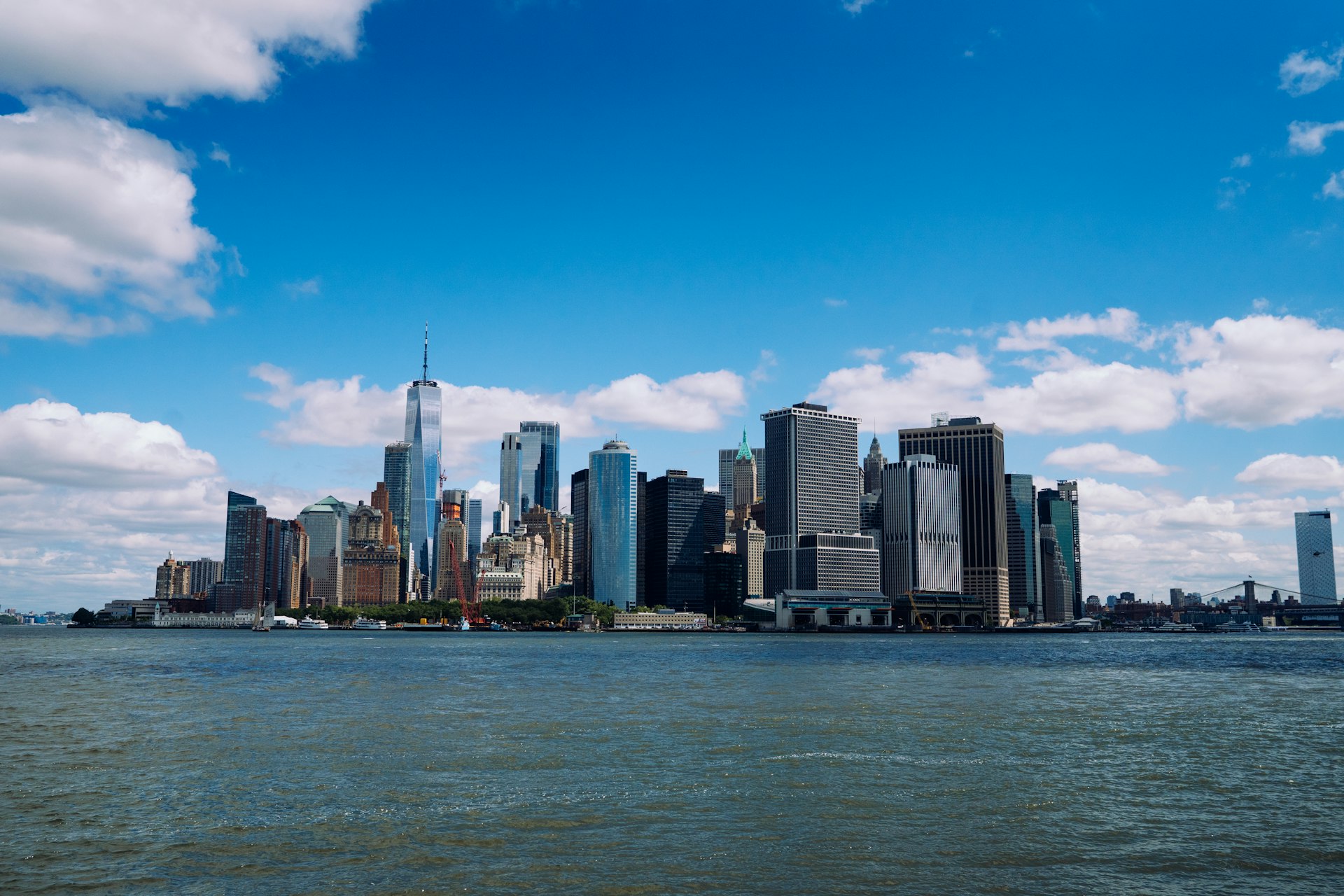 A vibrant financial district skyline under daylight, representing global markets.