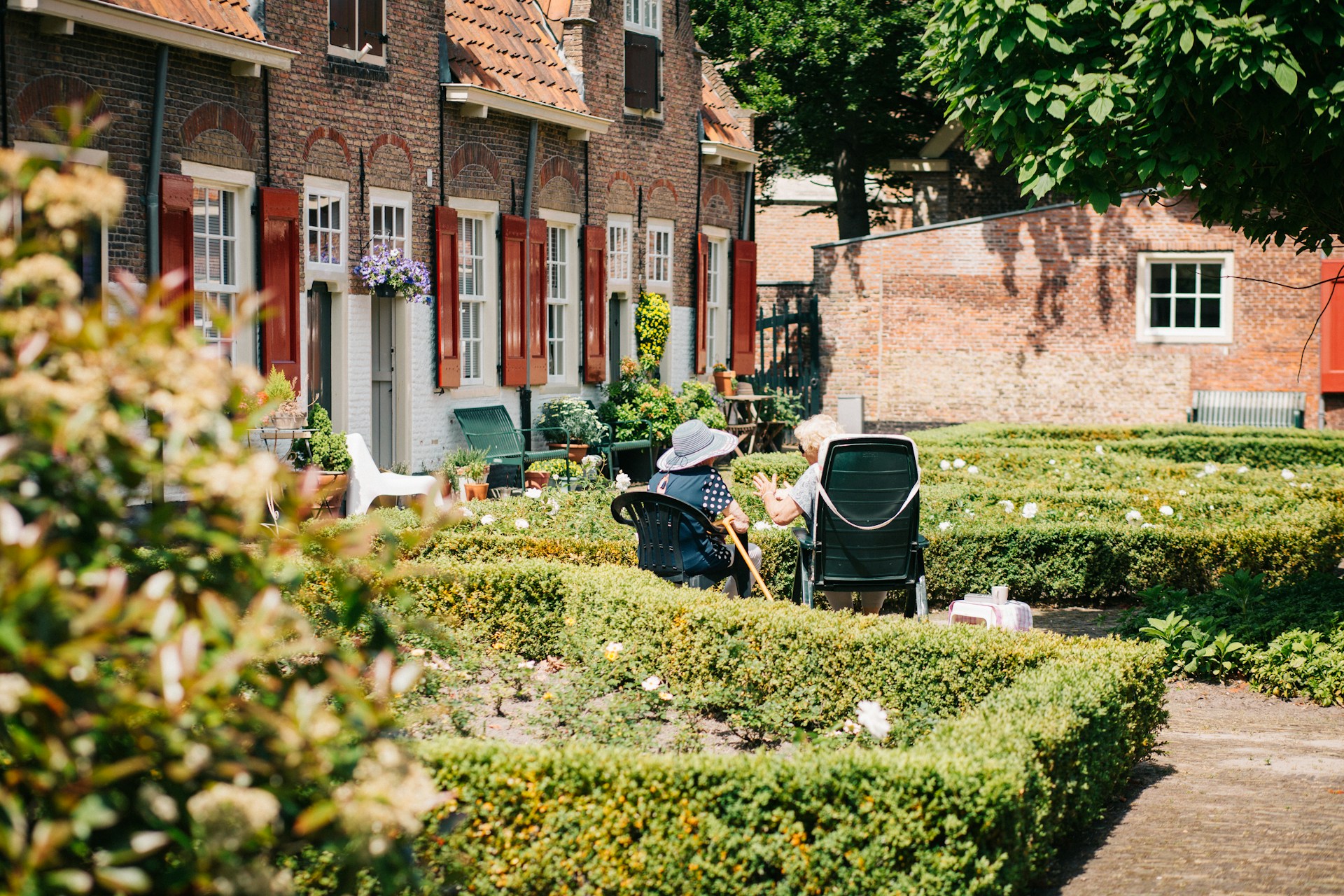 Elderly residents in the garden of a senior living community