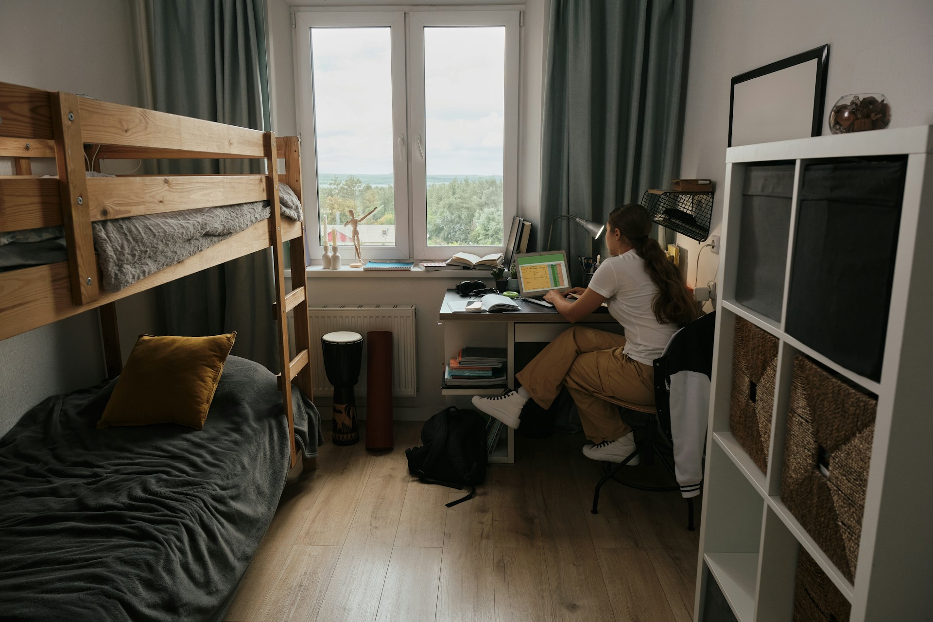 Student studying at a desk in a purpose-built accommodation room