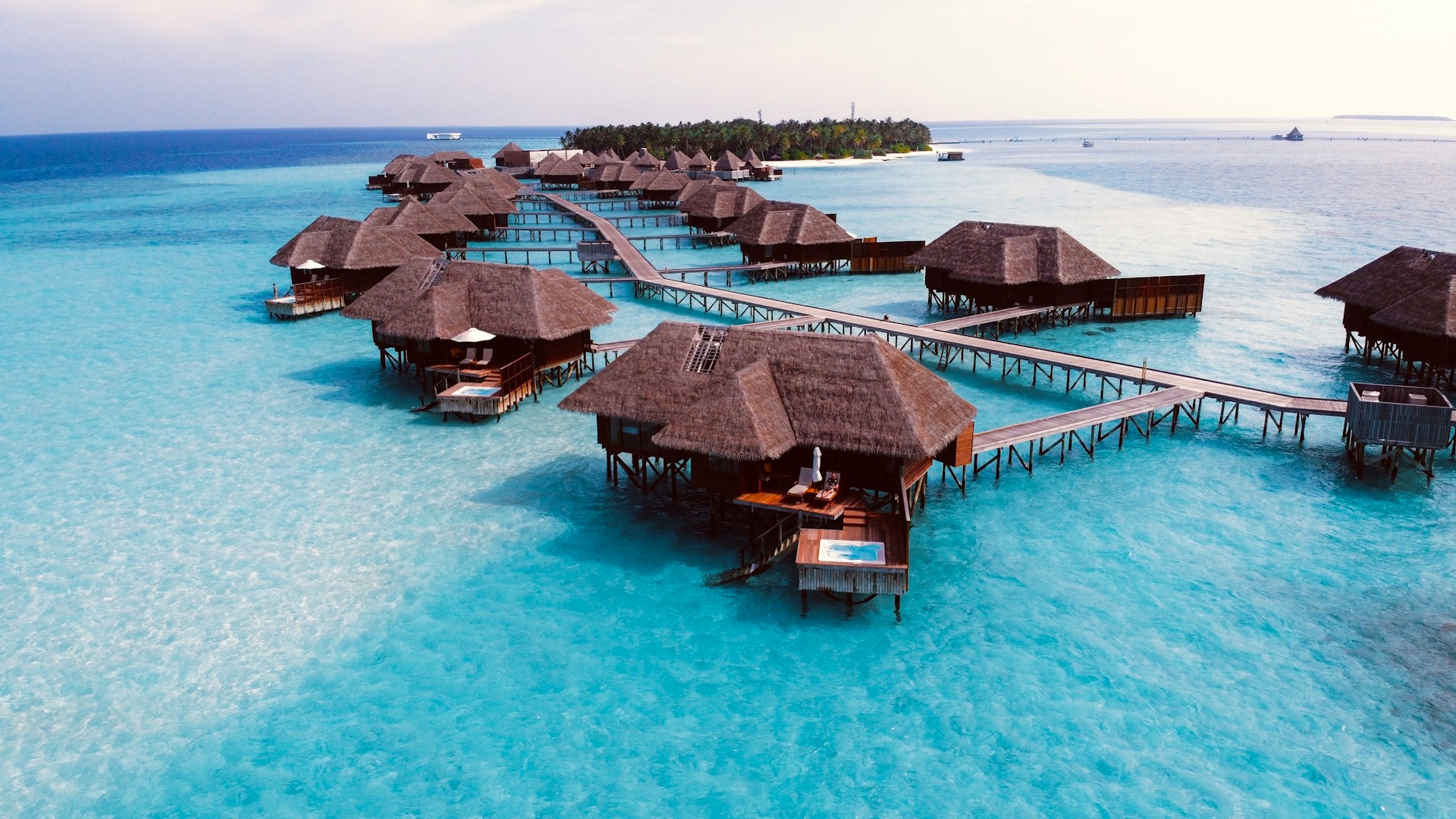Overwater villas on stilts above a tropical lagoon