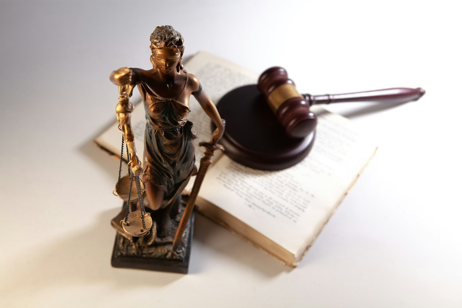 Judge's gavel resting on legal books in a courtroom