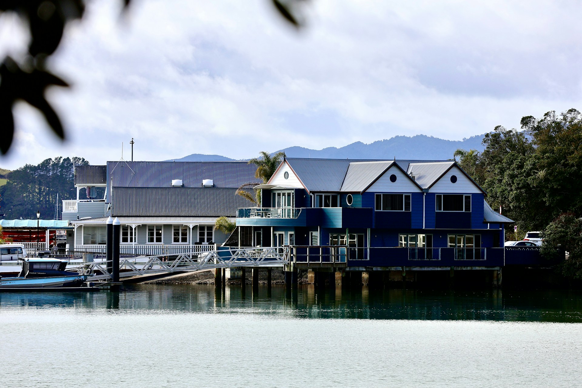 Waterfront vacation rental property on stilts with a private dock and boats