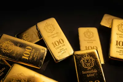 Shiny gold bullion bars stacked