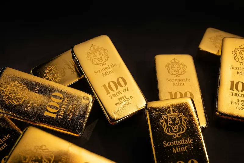 Shiny gold bullion bars stacked